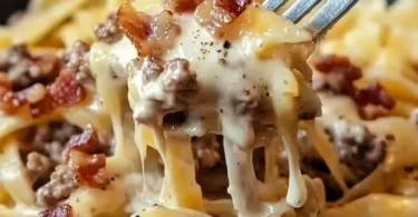 Loaded Bacon Cheeseburger Alfredo Pasta topped with crispy bacon and cheese